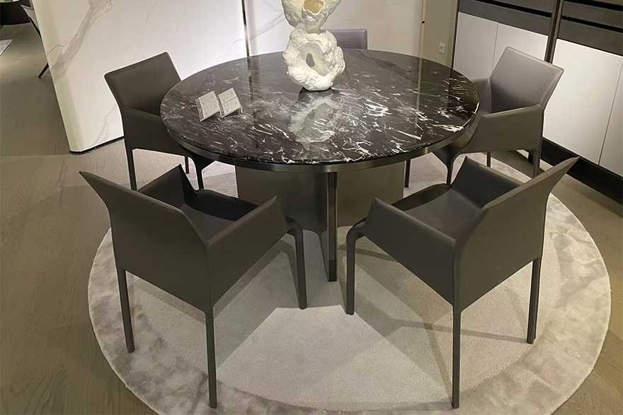 Black Round Marble Dining Table - High-End Contemporary Style A black round marble dining table with a black natural marble tabletop and a solid wood base with powder coated steel, showing a luxurious texture.